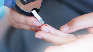 Photo of a finger being pricked to test blood sugar