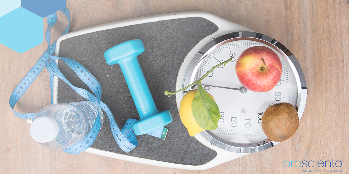 scale with health-related items on top (water bottle, tape measurer, weight, and fruit)