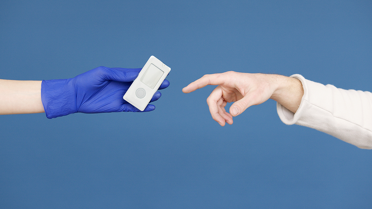 photo of a medical professional passing a continuous glucose monitor to a patient